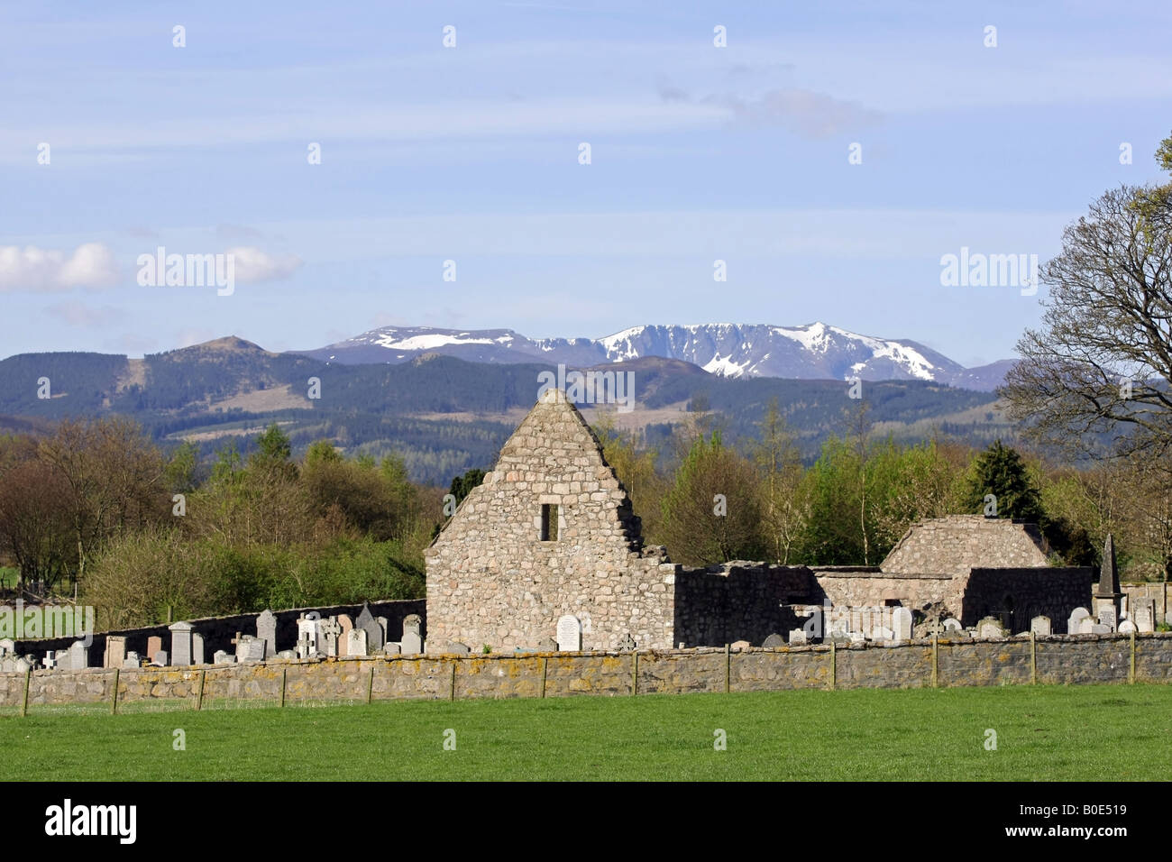La rovina di Tullich kirk vicino a Ballater, Aberdeenshire, Scozia, con la neve montagna ricoperte di Lochnagar in background Foto Stock