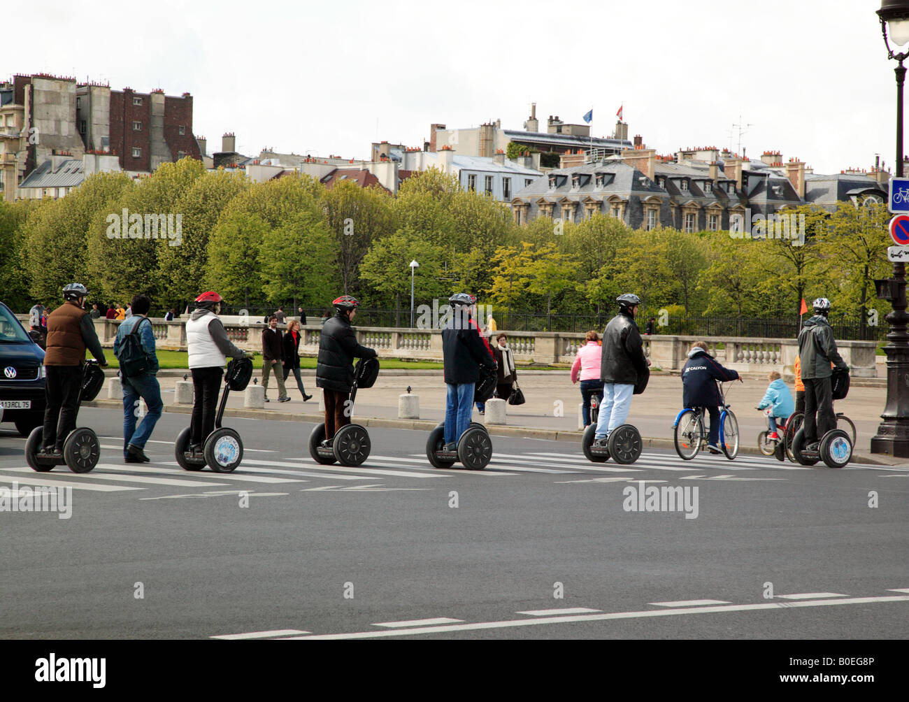 I turisti in sella eco-friendly di auto-equilibratura di veicoli elettrici come essi tour lungo le rive del fiume Senna a Parigi Foto Stock