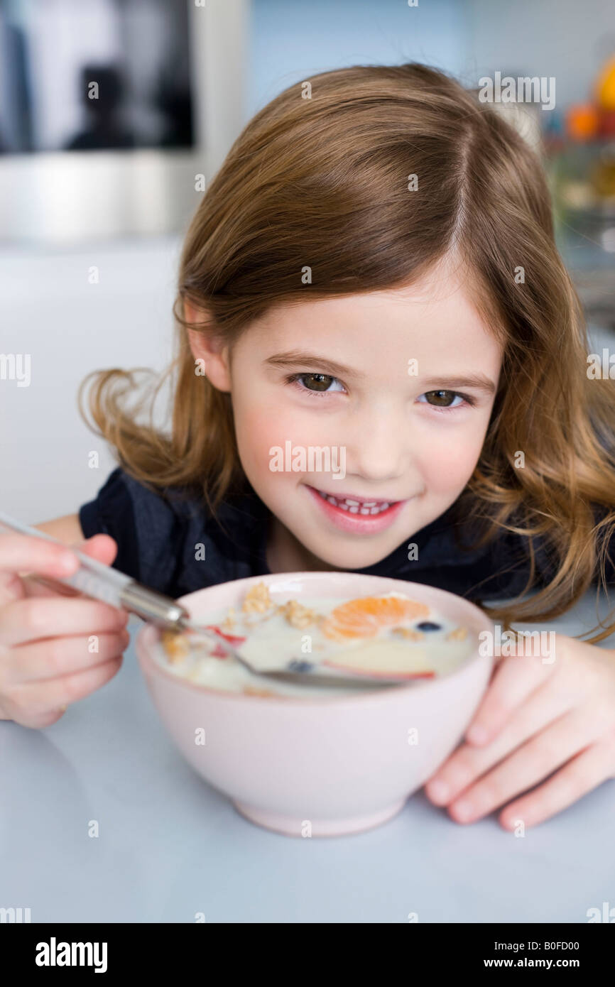 Ragazza di mangiare frutta e yogurt Foto Stock