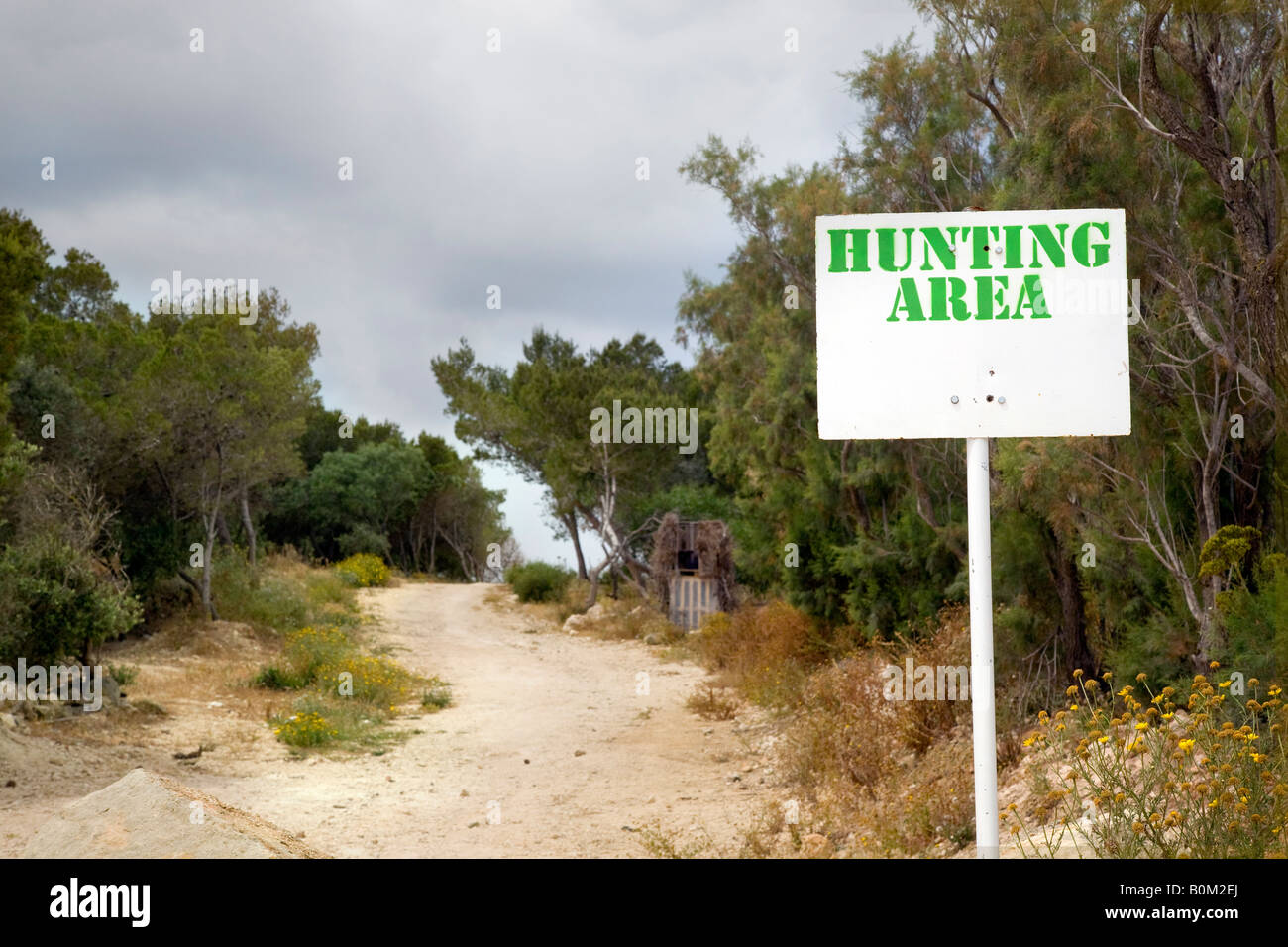 "Area di caccia" per gli uccelli. Una strada sterrata e vegetazione e Area di caccia segno di Malta. Foto Stock