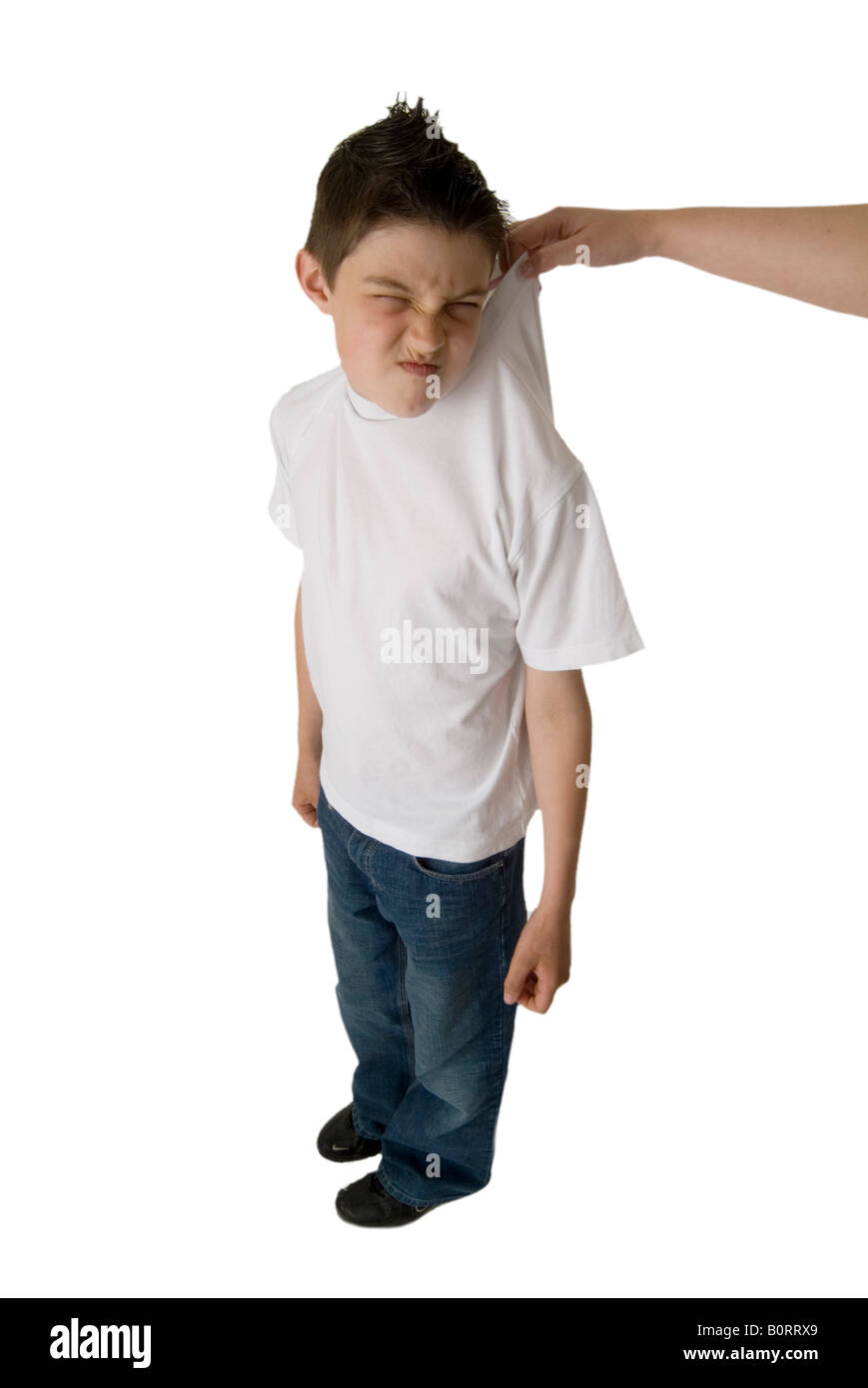 Naughty boy bambino cheeky afferrato dal collare sentiti catturati nell'atto trascinato dalla camicia Disapline Comportamento di detenzione in s Foto Stock