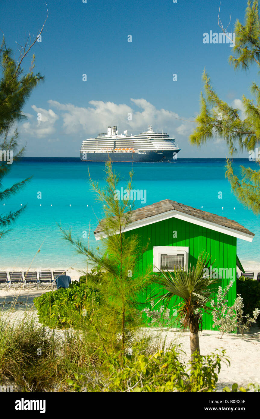 Un colorato verde beach cabana con la Holland America nave da crociera Westerdam ancorate al largo di Half Moon Cay Bahamas Foto Stock