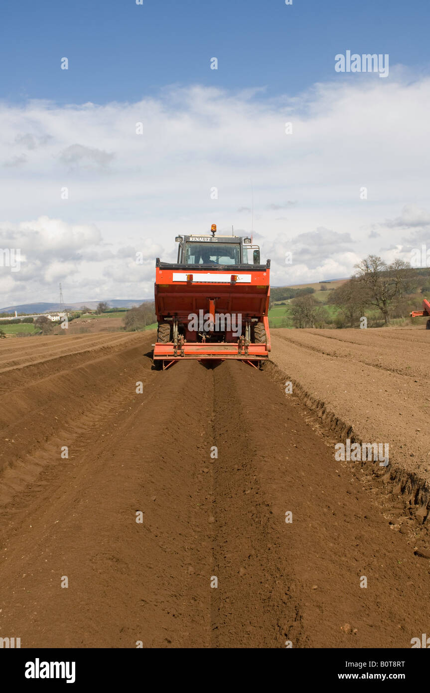 Piantare il seme di patate con una parte anteriore montato diretto concime trapanato applicatore attaccato a un trattore Cumbria Foto Stock