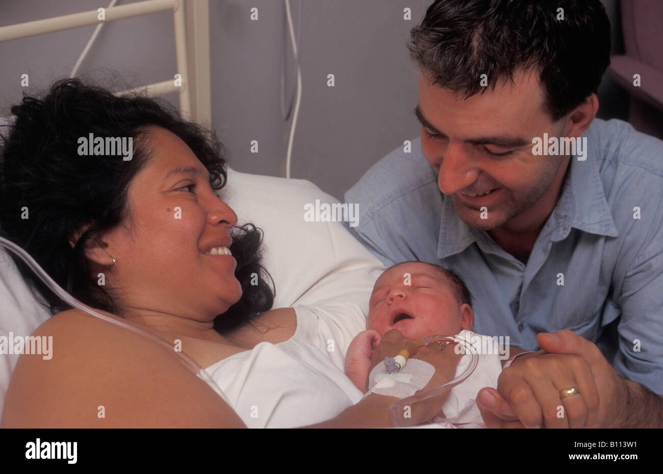 I genitori accogliente il loro neonato in ospedale suite di consegna Foto Stock