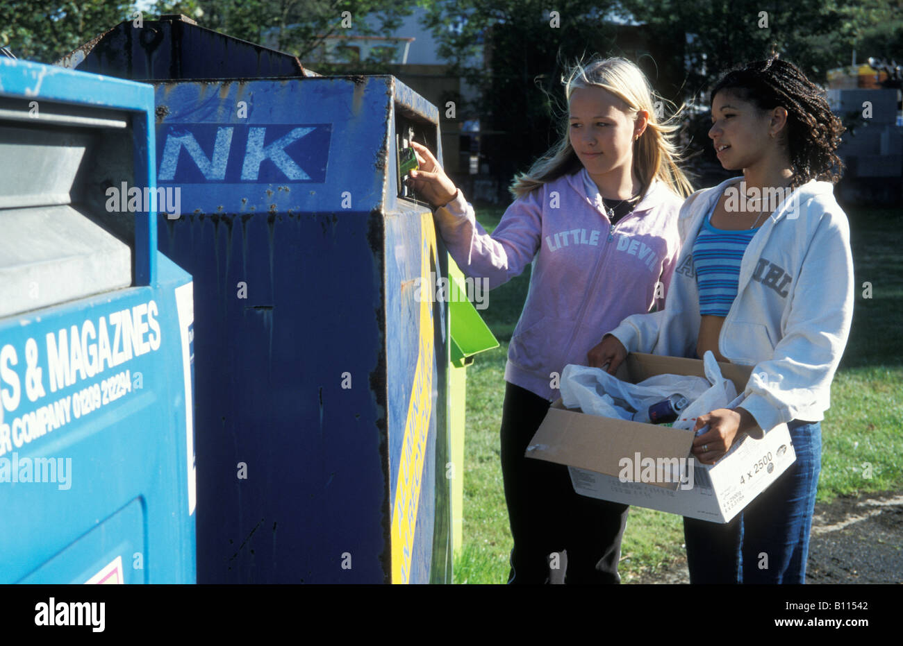 Due ragazze adolescenti del riciclaggio dei materiali a punto di riciclaggio Foto Stock