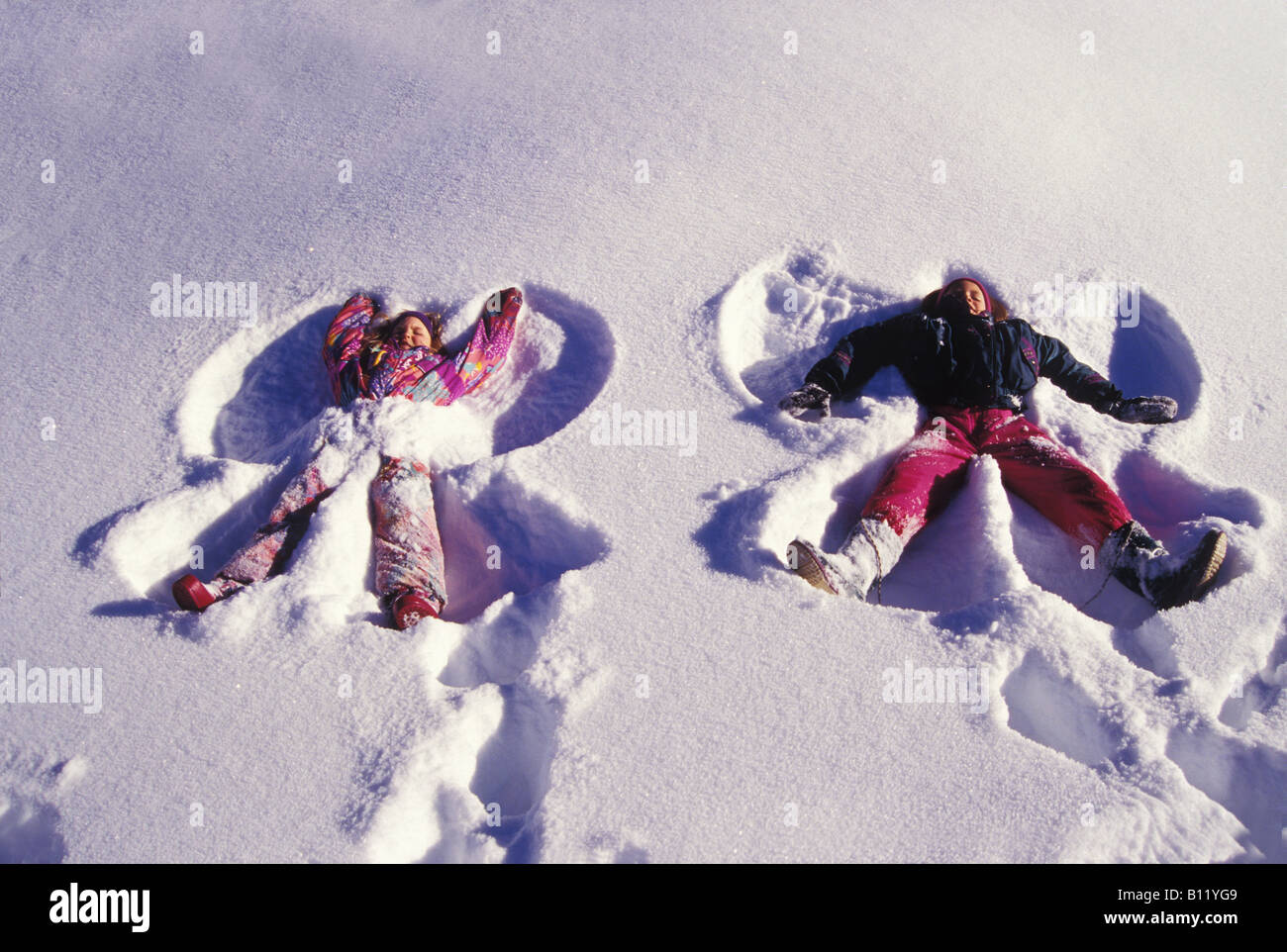 Due bambine di 8 e 9 anni di fare gli angeli di neve in appena caduta di  neve asciutta in Crested Butte Colorado Foto stock - Alamy