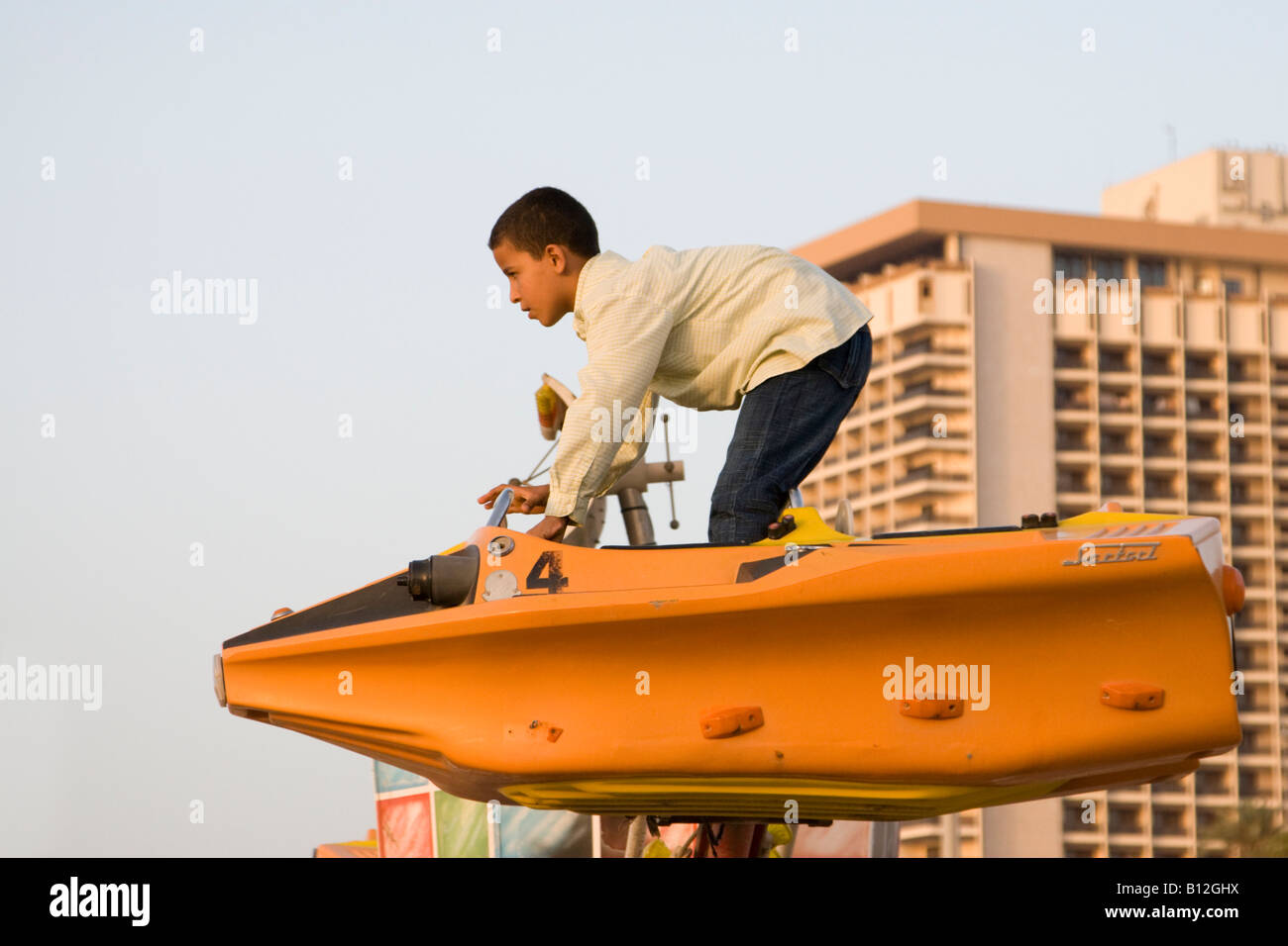 Tripoli in Libia Africa del Nord ragazzo libico in piedi nel parco dei divertimenti di corsa Foto Stock