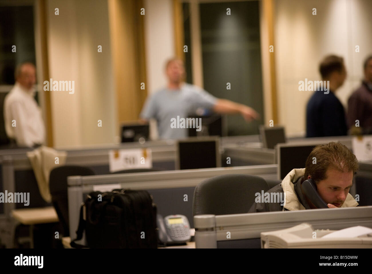 Un ingegnere prove il sistema telefonico in un nuovo ufficio montato. Foto Stock