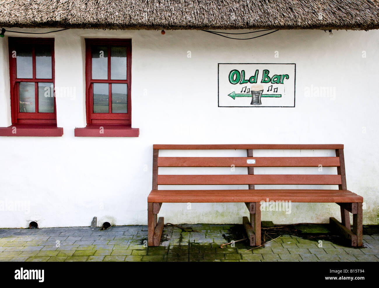 Esterno di un cottage con tetto di paglia e vecchi bar segno, nella contea di Clare Irlanda Foto Stock