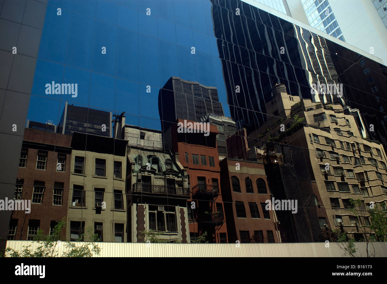 Midtown Manhattan edifici sono riflessi da pareti in vetro del Museo di Arte Moderna Foto Stock