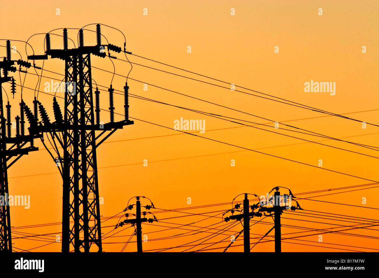 Settore energia / elettricità ad alta tensione torri di trasmissione stagliano al tramonto. Foto Stock