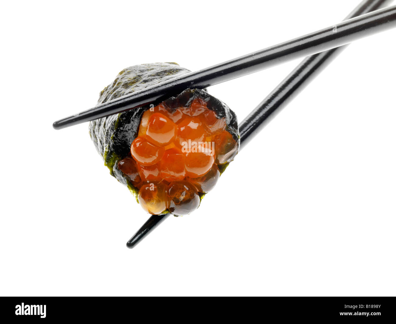 Un autentico stile tradizionale giapponese Sushi snack detenute con bacchette isolata contro uno sfondo bianco con nessun popolo e un tracciato di ritaglio Foto Stock