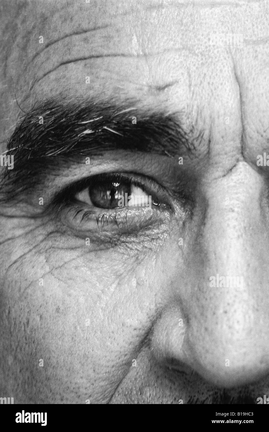 Uomo maturo, guardando la telecamera, close-up di occhio, in bianco e nero Foto Stock