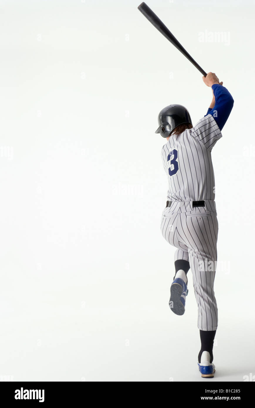 Giocatore di baseball in piedi con una gamba sola Foto Stock