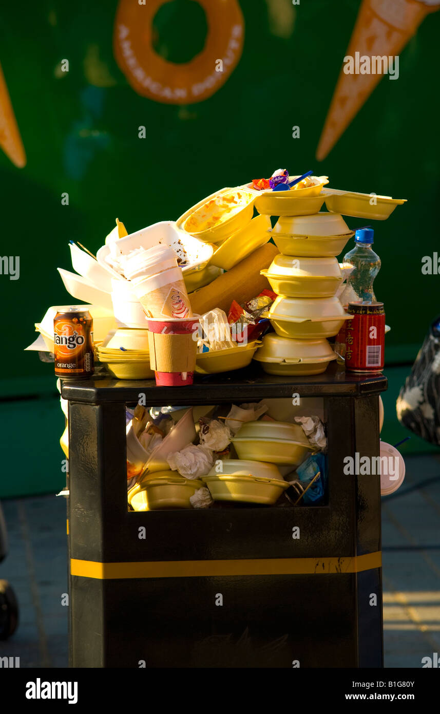 Il fast food contenitori impilati e traboccante sulla parte superiore della pubblica spazzatura Foto Stock