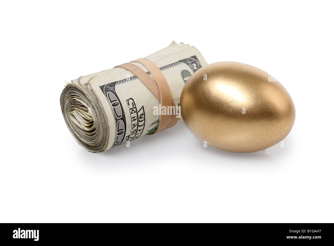 Denaro e Golden Egg ritagliata su sfondo bianco Foto Stock