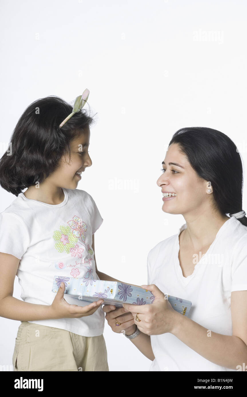 Metà donna adulta dando un regalo per sua figlia Foto Stock