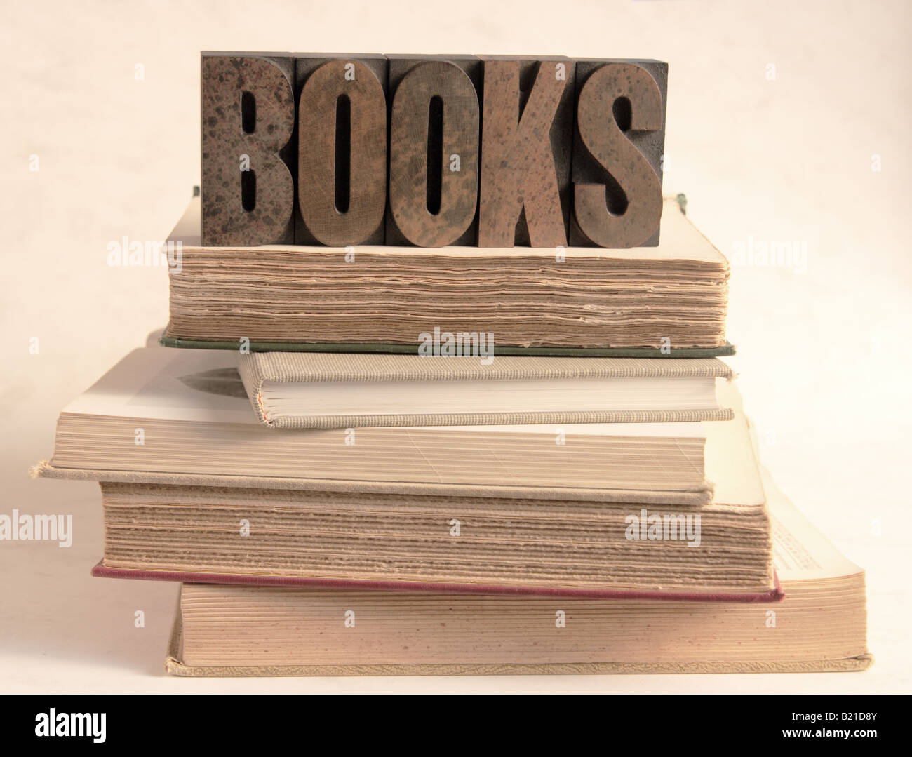 La parola 'Libri' in inchiostro colorato tipo di stampa in rilievo sulla sommità di una pila di vecchi libri Foto Stock