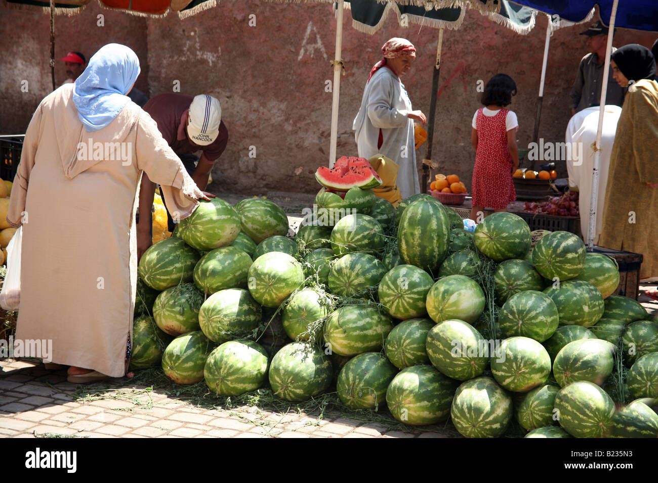 Una donna locale acquisto di cocomeri di Marrakech Foto Stock