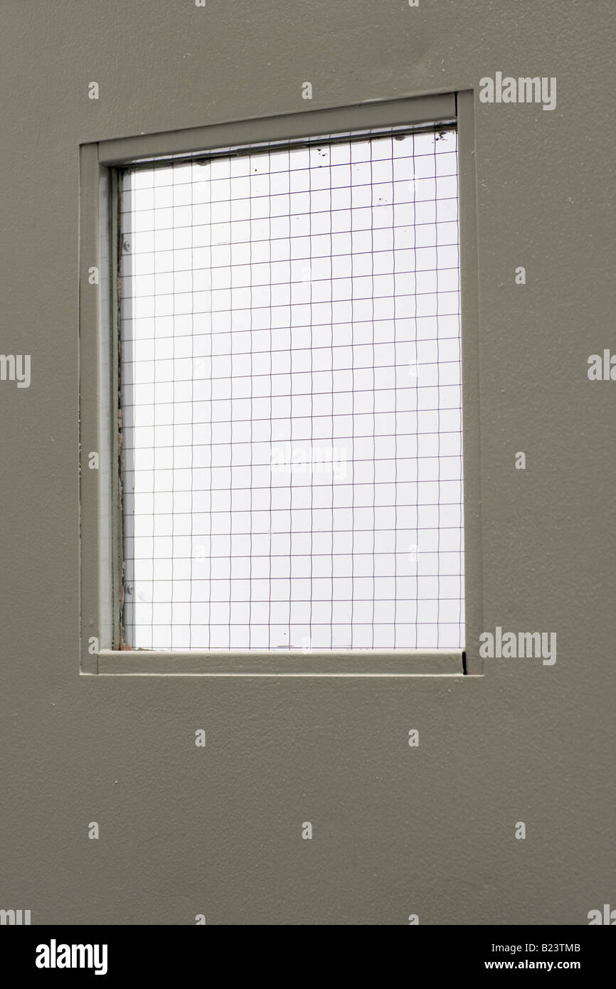 La porta di metallo con finestra a maglie Foto Stock