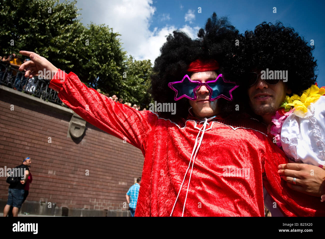 Due giovani uomini con grandi parrucche e occhiali da sole celebrare un tedesco di musica di paese il partito Schlagermove ad Amburgo, Germania Foto Stock