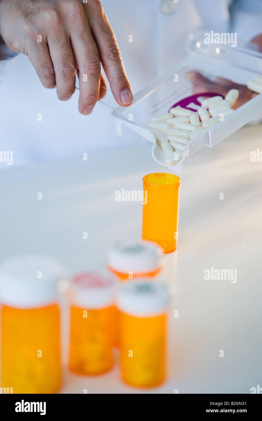 Il farmacista di riempimento della bottiglia della pillola Foto Stock