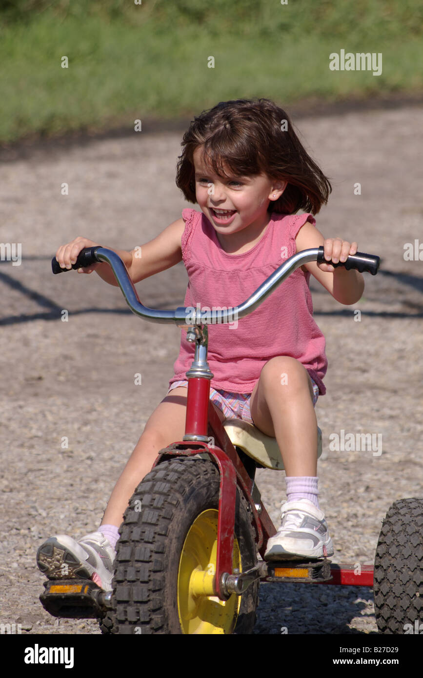 4 5 anni ragazza in sella ad una 3 ruote moto Foto Stock