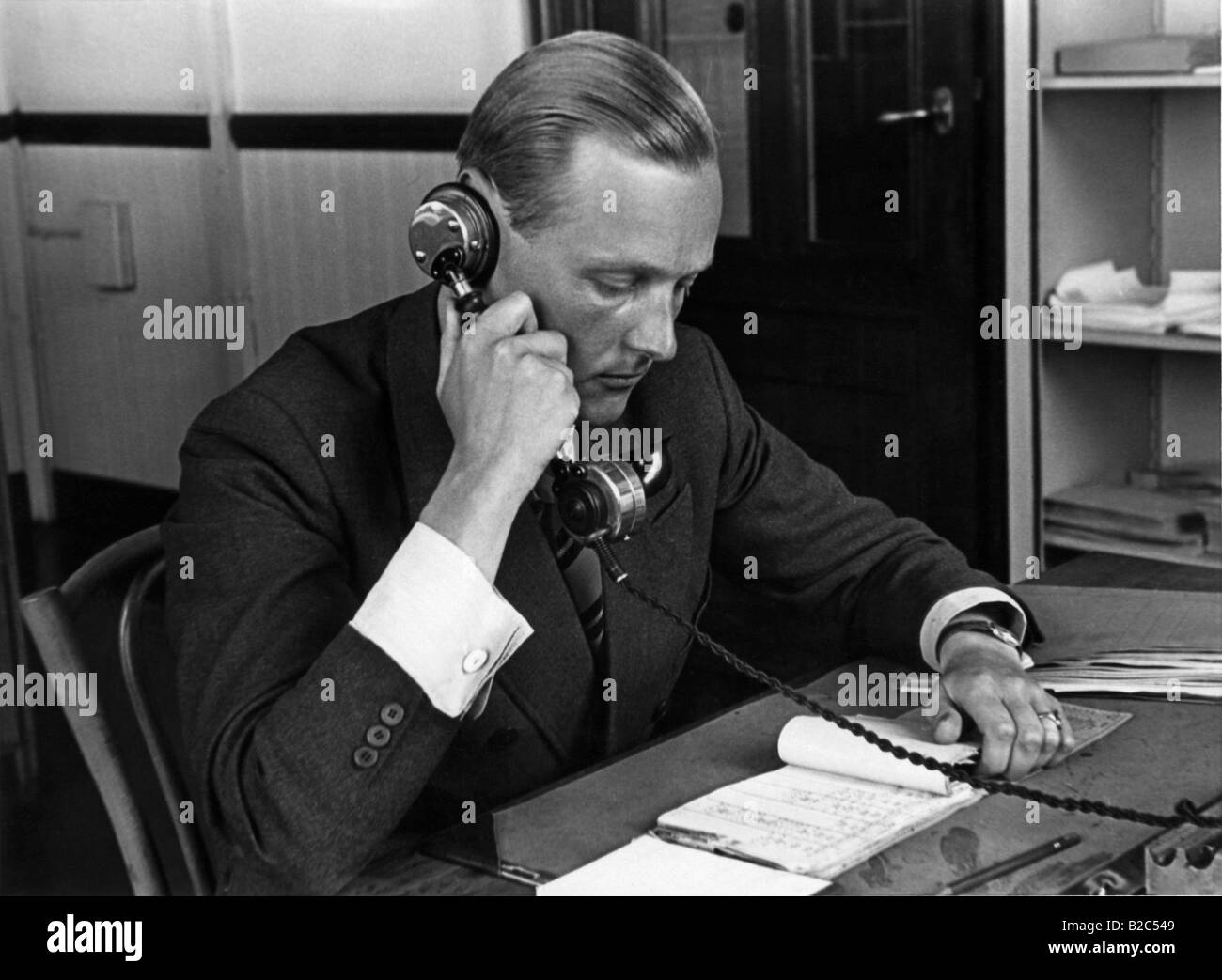 Uomo di dover telefonare nel suo ufficio, foto storiche da circa 1940 Foto Stock