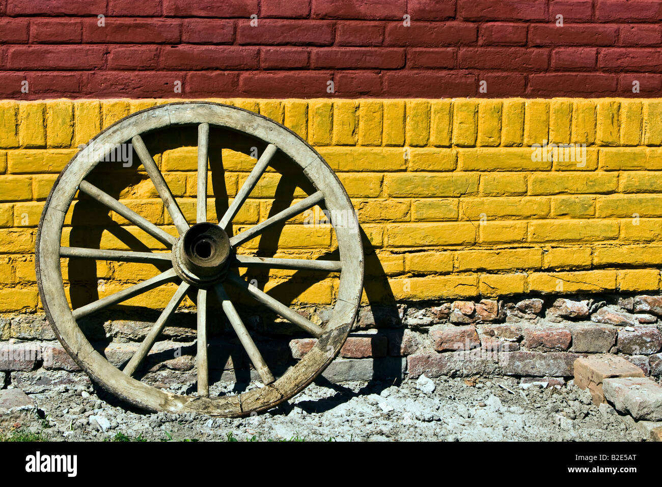 Vecchia ruota di legno contro una parete Foto Stock
