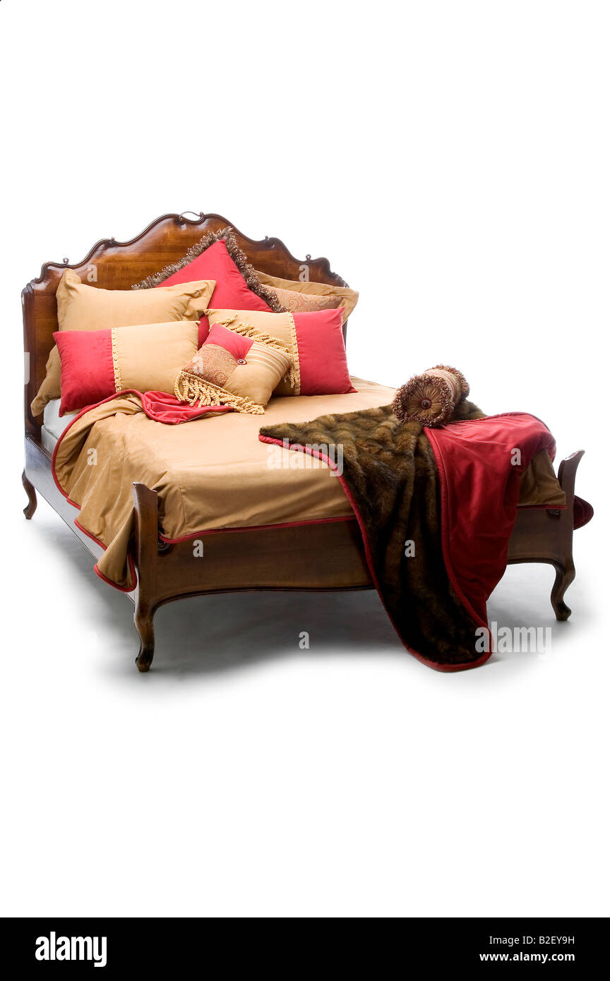 Un elegante letto in stile vittoriano con oro rosso e pellicce Foto Stock