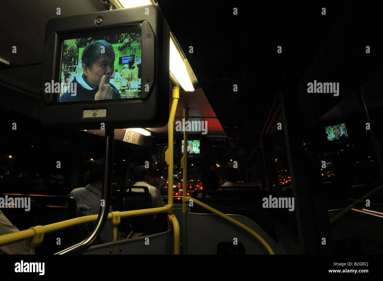 Guardare la TV su modern double decker con aria condizionata autobus di Singapore Foto Stock