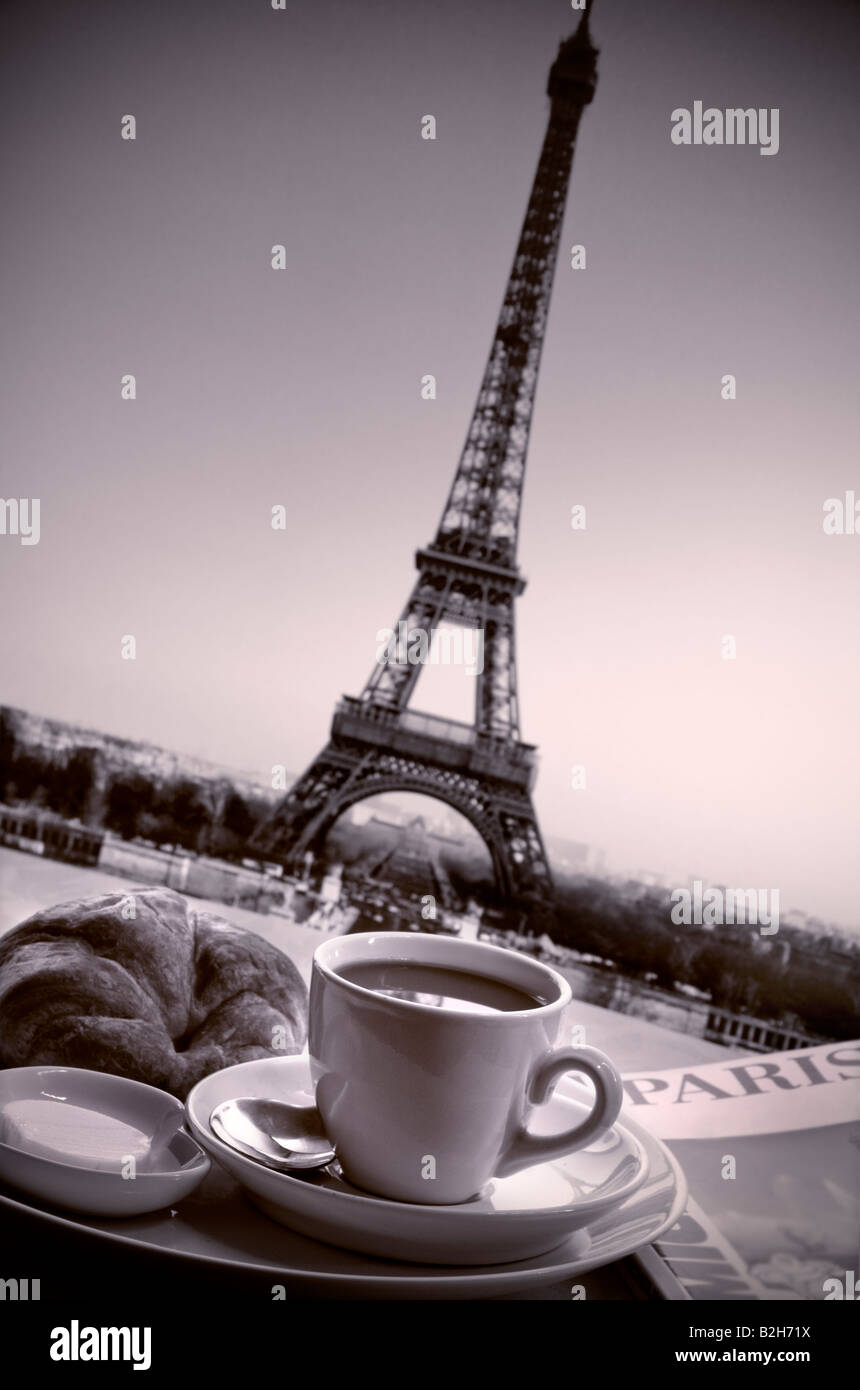 Immagine in bianco e nero di francese colazione a base di caffè e croissant sulla tavola con la Torre Eiffel sullo sfondo Parigi Francia Foto Stock