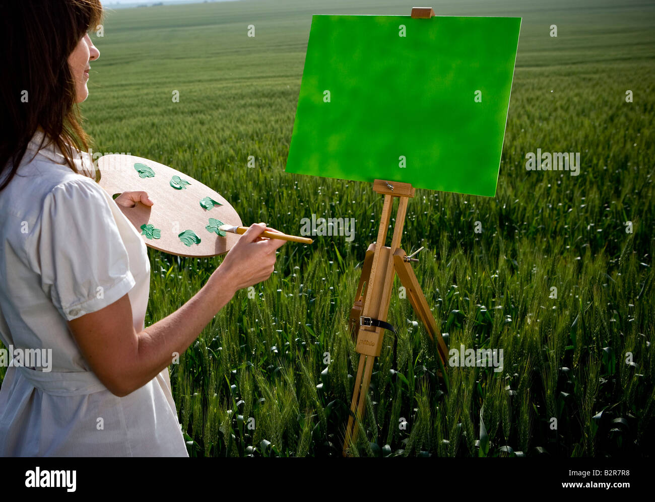 Pittura donna nel campo di grano Foto Stock