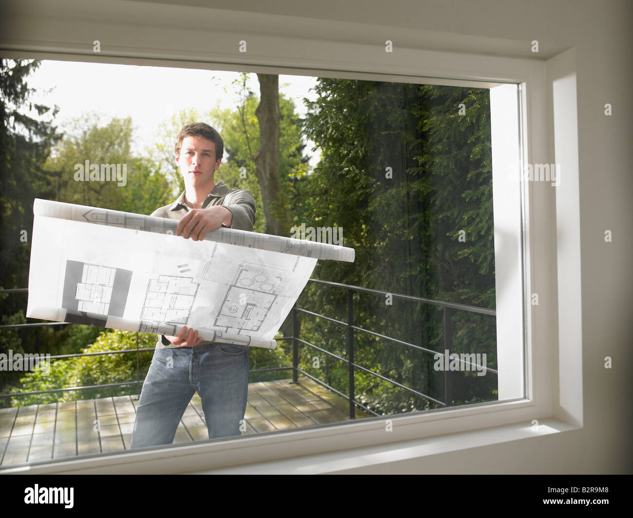 Uomo con blueprint, all'aperto Foto Stock