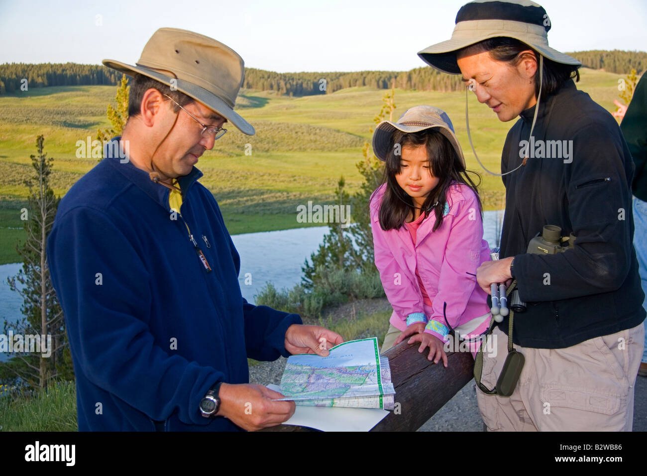 Famiglia asiatica mappatura della loro visita al Parco Nazionale di Yellowstone Wyoming Foto Stock