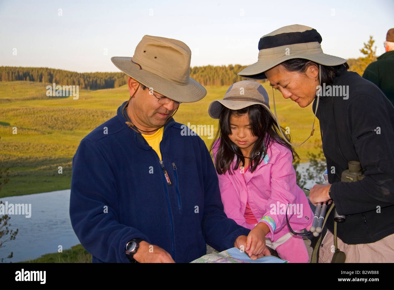 Famiglia asiatica mappatura della loro visita al Parco Nazionale di Yellowstone Wyoming Foto Stock