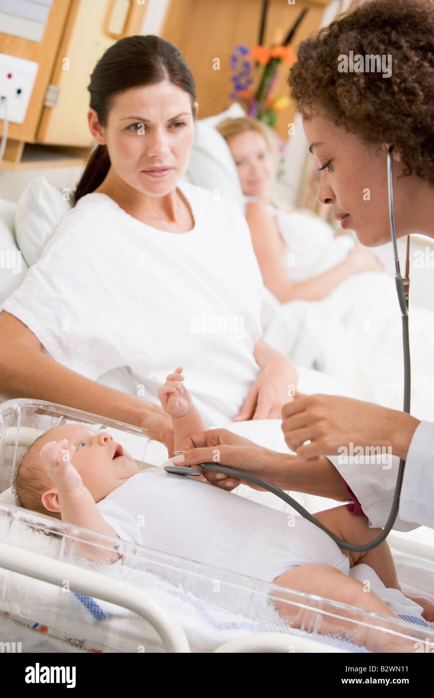 Il controllo medico del bambino con heartbeat nuova madre guardando Foto Stock