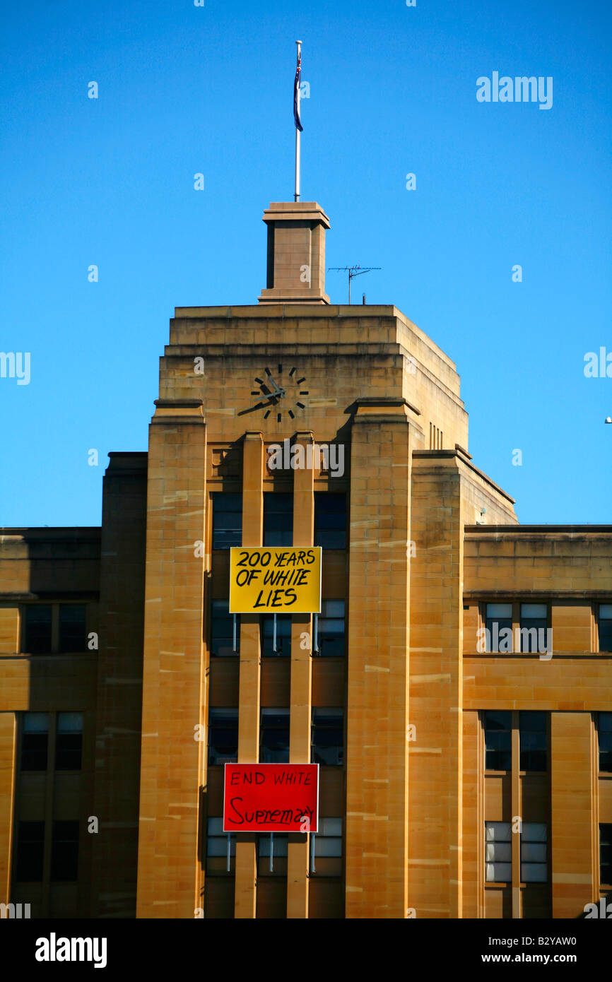 Segni che accusano australiano di razzismo sono visualizzati sul Museo di Arte Contemporanea di Circular Quay di Sydney Australia Foto Stock