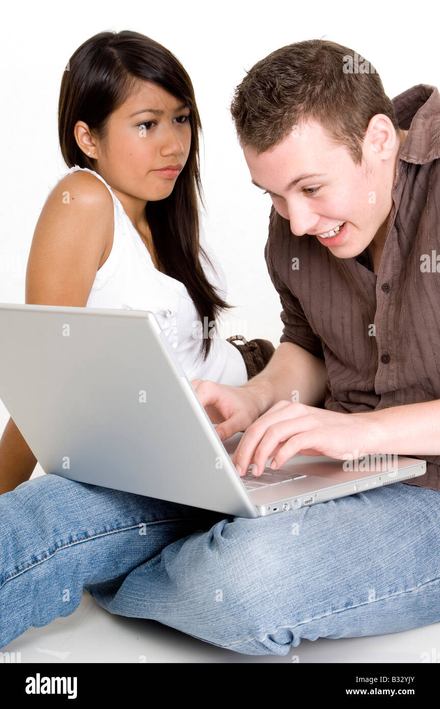 Un giovane ragazzo infastidisce la sua ragazza essendo il computer per tutto il tempo Foto Stock