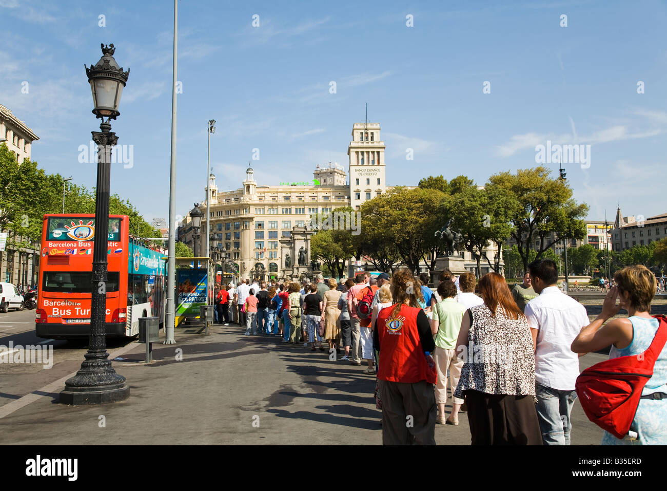 Spagna Barcellona turisti attendere in linea a bordo double decker bus turistico in Plaza de Catalunya Foto Stock