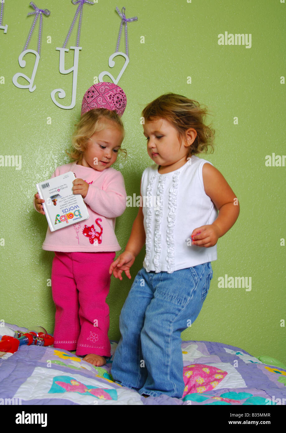 Due ragazze in piedi sul letto e la riproduzione Foto Stock