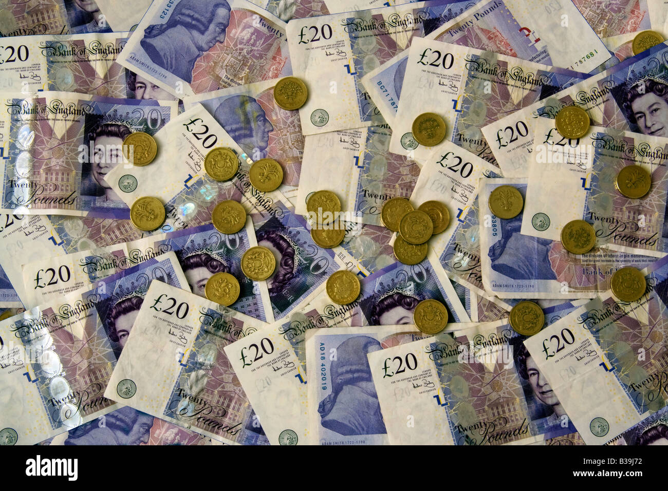 Venti Pound monete e banconote denaro Foto Stock