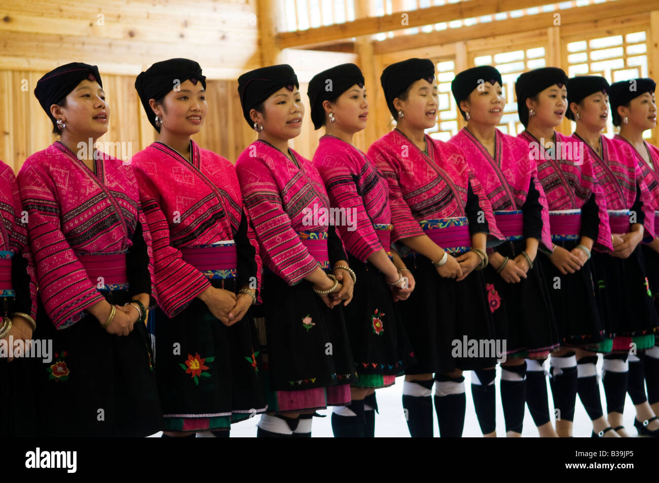 Un gruppo colorato di Yao donne eseguendo una danza tradizionale nel loro villaggio Foto Stock