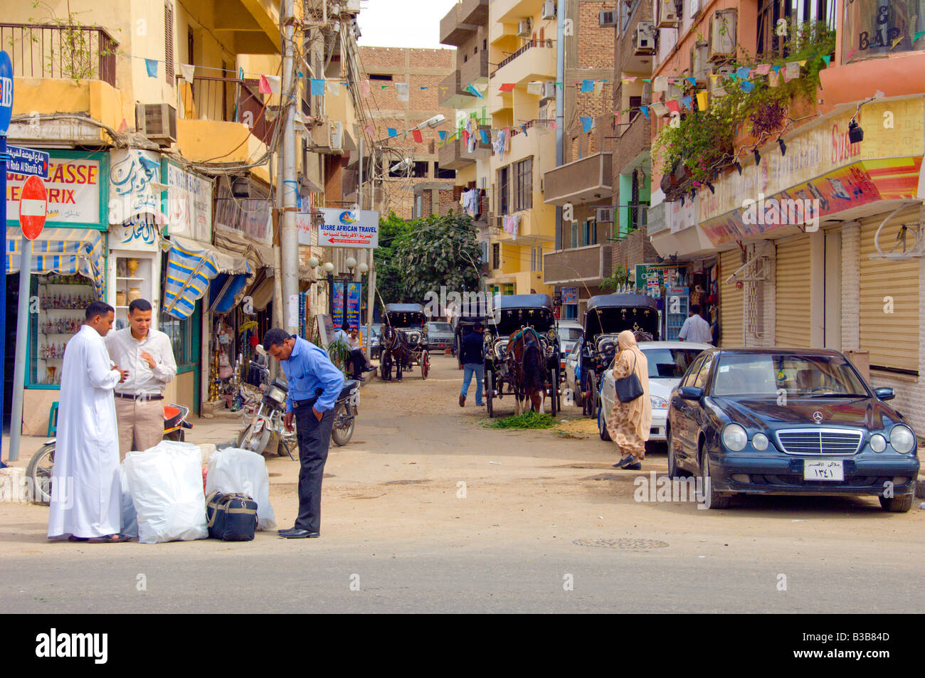 Le attività di strada con i negozi e gli amanti dello shopping a Luxor Egitto Foto Stock