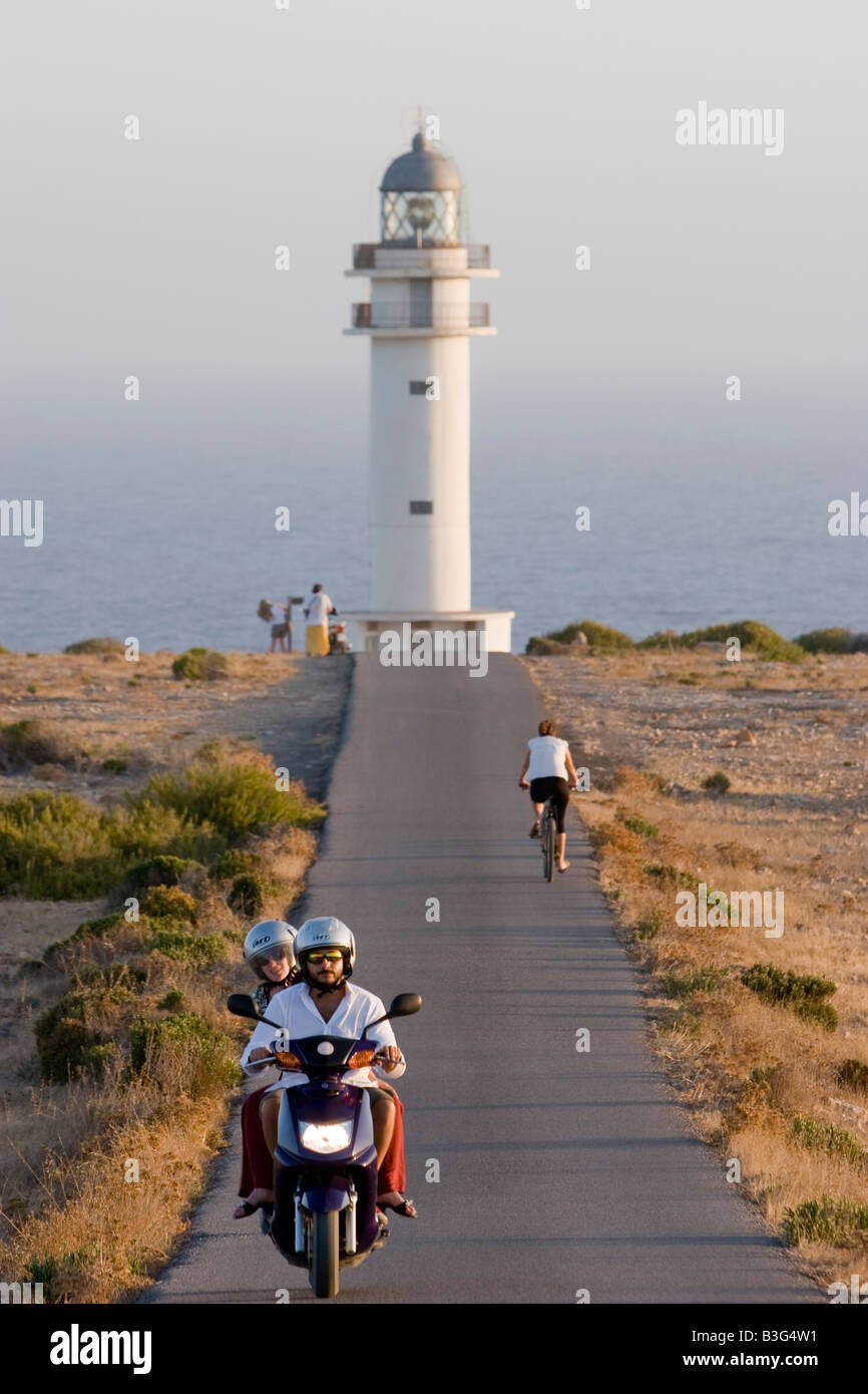 Due giovani motociclisti su una lunga strada di Es Cap de Barbaria faro, a Formentera, isole Baleari Foto Stock