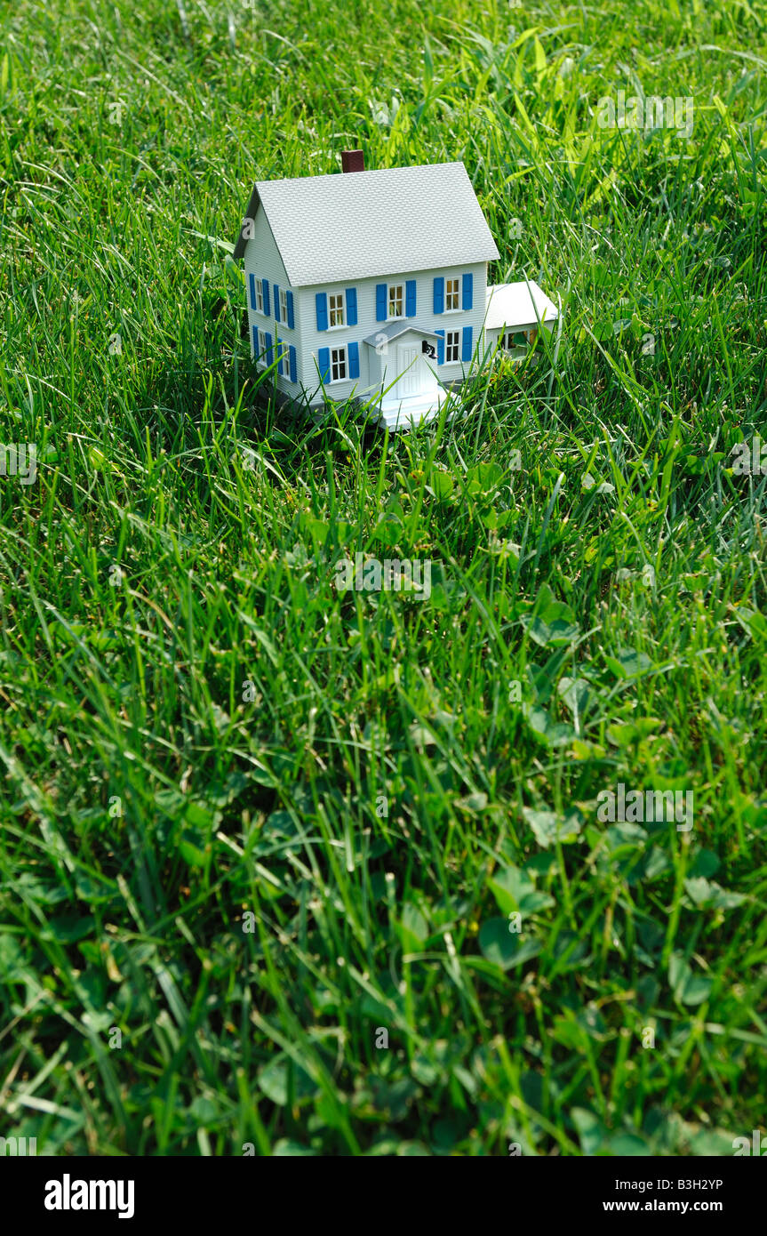 Una piccola casa di plastica in vera erba verde Foto Stock