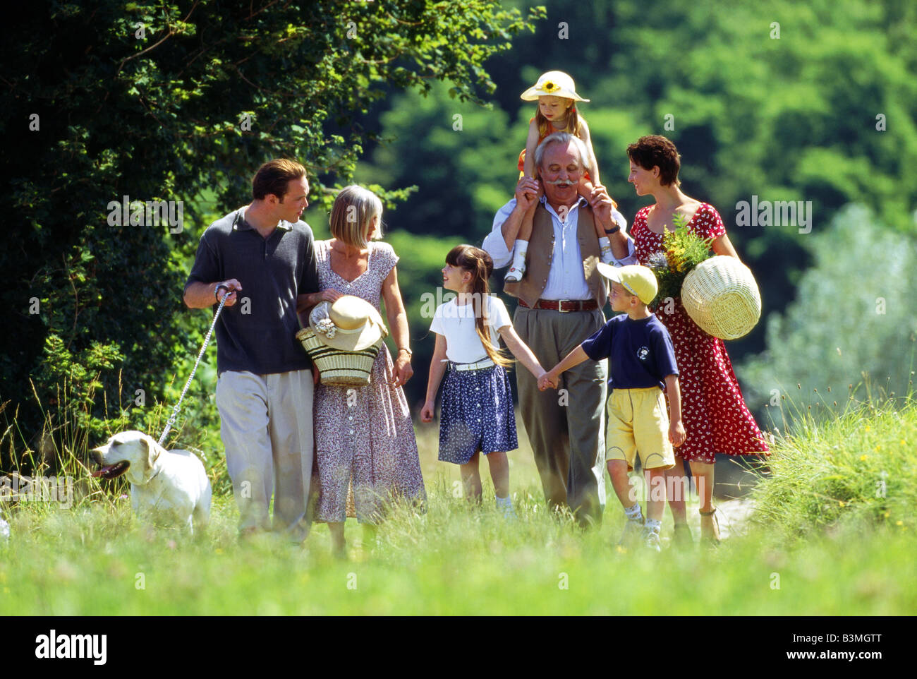 Famiglia passeggiate in erba Famille avec 3 générations en promenade dans la natura Foto Stock