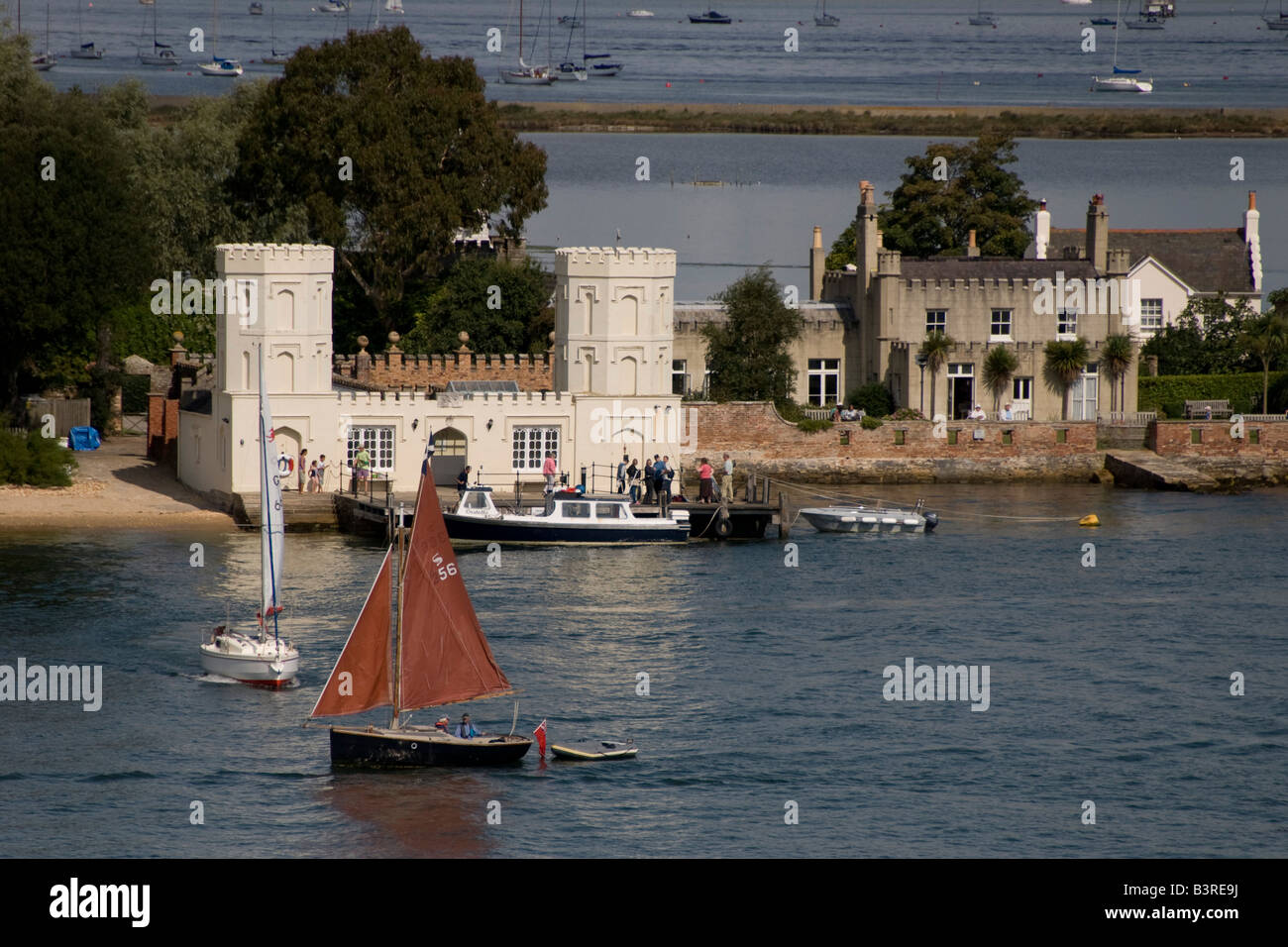 Piccole barche a vela passato punto di atterraggio su Brownsea Island, Poole, Dorset, Regno Unito Foto Stock