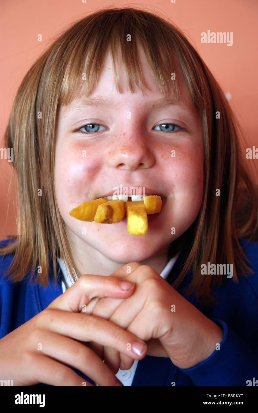 Da studentessa con un boccone di profonda patatine fritte Foto Stock