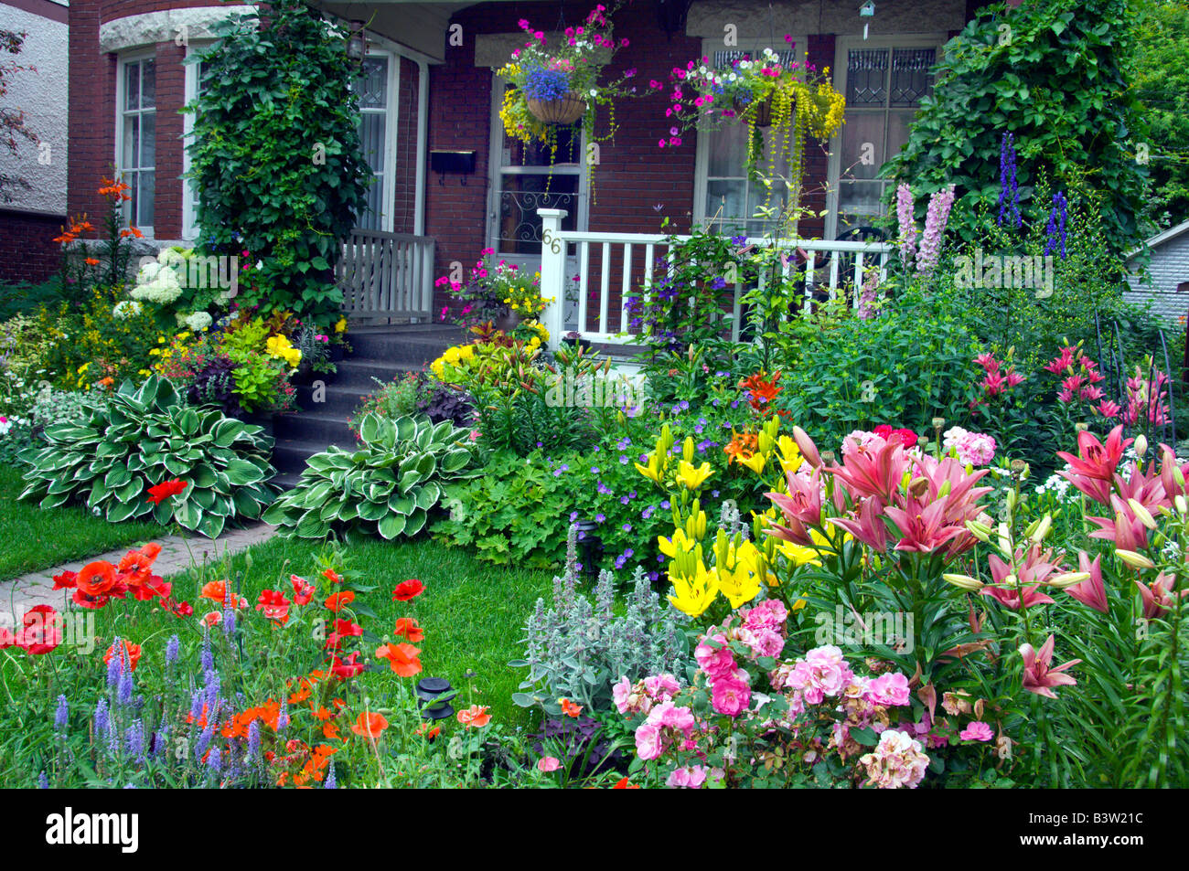 Wolseley area home con decorativi fiori di primavera nel cortile anteriore e sui viali di Winnipeg, Manitoba, Canada. Foto Stock